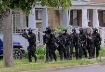The Peterborough police's emergency response team approaching a home on Lock Street on June 24, 2021. Police were executing a search warrant, seized a quantity of crystal methamphetamine, and arrested and charged three people with various offences. (Screenshot from supplied video)