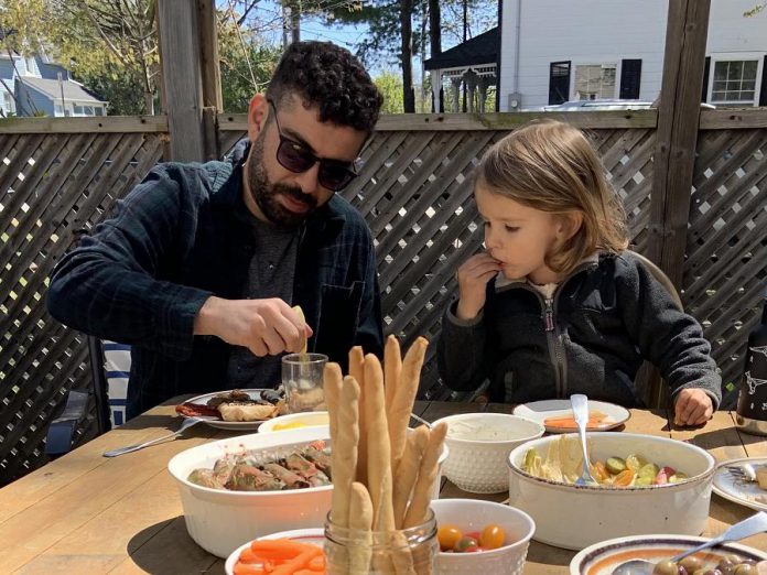 Tuncay Alkan enjoying a meal with his family. Cooking Middle Eastern food here in Canada helped him to adjusted to his new country by connecting him back to the land, culture, and family he left behind in Turkey. He also speaks with his family in Turkey on the phone almost every day.  (Photo courtesy of the Alkan family)