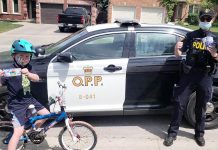 A child with a coupon for a free 'Froster' at a local Circle K convenience store from a local OPP officer. Under the OPP's positive ticketing program, kids will be rewarded this summer for practising personal safety (such as by wearing a bicycle helmet), performing good deeds, and more. (Photo: OPP)