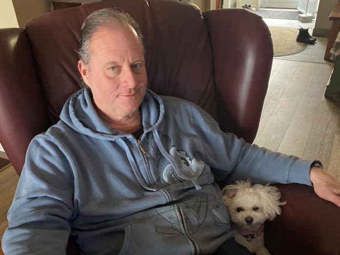 Peter Blodgett, owner of Darling Insurance, with Lexie. Although Blodgett is allergic to all animals, he has donated $100,000 towards the construction of the Peterborough Humane Society's new animal care centre. (Supplied photo)