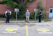 Two Project Safe Trade parking spots are available at the Bancroft OPP Detachment in Lindsay at 64 Monck Road in Bancroft, providing a public location to complete property transactions arranged on the internet. Pictured are Bancroft community safety and wellbeing committee chair Charles Mullett, staff sergeant Jeff MacKinnon, and provincial constable Susanne Cox. (Photo courtesy of Bancroft OPP)