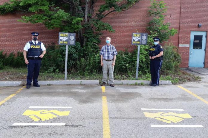 Two Project Safe Trade parking spots are available at the Bancroft OPP Detachment in Lindsay at 64 Monck Road in Bancroft, providing a public location to complete property transactions arranged on the internet. Pictured are Bancroft community safety and wellbeing committee chair Charles Mullett, staff sergeant Jeff MacKinnon, and provincial constable Susanne Cox. (Photo courtesy of Bancroft OPP)
