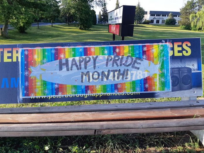 A flag placed on a bench in front of Holy Cross Catholic Secondary School and the Catholic Education Centre at 1355 Lansdowne Street West in Peterborough. (Photo courtesy of Kimberly Liane)