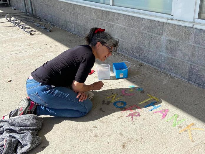 Carolyn Collins started writing uplifting chalk messages on her driveway in order to utilize her daughters leftover chalk supplies. After receiving a lot of positive feedback, Collins decided to make it apart of her Walk About Clown fun. (Photo courtesy of Carolyn Collins)