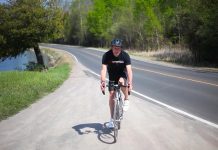 Peterborough musician and puppeteer Glen Caradus training for his 350-kilometre bike ride on August 7, 2021 to raise awareness of climate change and funds for Peterborough GreenUP's climate-related programming. (Screenshot by kawarthaNOW from promotional video by Jeremy Kelly)