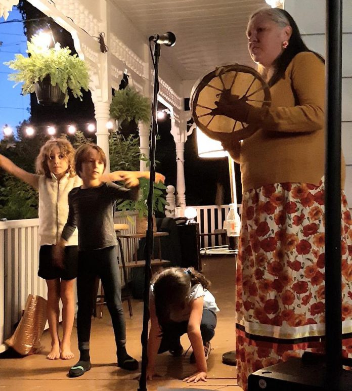 Tiphaine and Rosemary have loved watching the Bonaccord neighbourhood children get involved with the porch concert series. Pictured are children acting out animals as a part of Indigenous hand drummer Janet McCue's performance last summer. (Photo courtesy of Tiphaine Lenaik)
