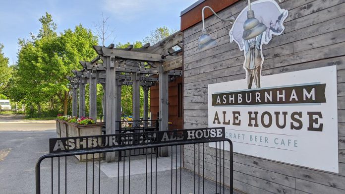 Ashburnham Ale House's logo pays tribute to Daniel "Dan" Macdonald, a late 19th-century occupant of the original building who became known as "Peterborough’s Strongest Man" for lifting heavy objects over his head, including animals like pigs.  (Photo: Bruce Head / kawarthaNOW)