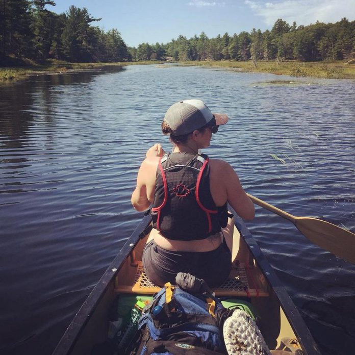 Christine Hoogkamer, pictured paddling in a canoe in Kawartha Highlands Provincial Park, lives across from Emily Provincial Park. Hoogkamer uses her Instagram account to spread awareness about the importance of respecting nature while enjoying outdoor recreational activities. (Photo courtesy of Christine Hoogkamer)