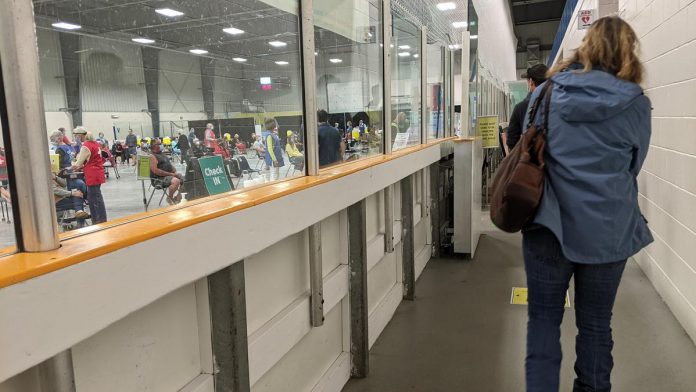 Peterborough-area residents stand in line waiting for a dose of COVID-19 vaccine at the Evinrude Centre on July 8, 2021. (Photo: Bruce Head / kawarthaNOW)