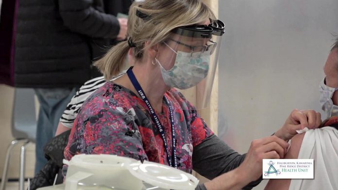 A resident receives a COVID-19 vaccination at the Fenelon Falls immunization clinic. (Screenshot from HKPRKHU video by kawarthaNOW)