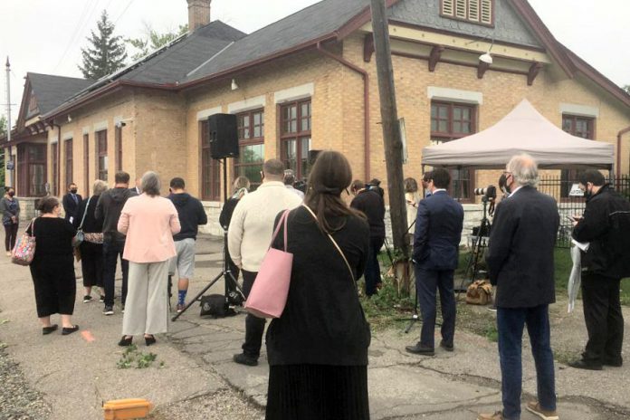 A large crowd gathered outside the historic CPR train station off George Street on July 8, 2021 as preliminary details of a new High Frequency Rail line that will bring passenger rail service back to Peterborough were revealed by federal Transport Minister Omar Alghabra.  (Photo: Paul Rellinger / kawarthaNOW)