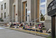 After the remains were discovered of 215 Indigenous children buried at the former Kamloops Indian Residential School in British Columbia in May 2021, the Indigenous community of Nogojiwanong-Peterborough created a memorial on the steps of Peterborough City Hall. On August 3, the 215th day of 2021, members of Curve Lake and Hiawatha First Nations will hold a day of mourning in Nogojiwanong-Peterborough to remember and recognize all Indigenous children whose lives were lost to Canada's residential school system. (Photo: Bruce Head / kawarthaNOW)