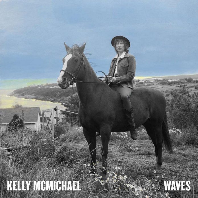 The cover of Kelly McMichael's first solo album "Waves" features her on a horse with the Atlantic Ocean as a backdrop.