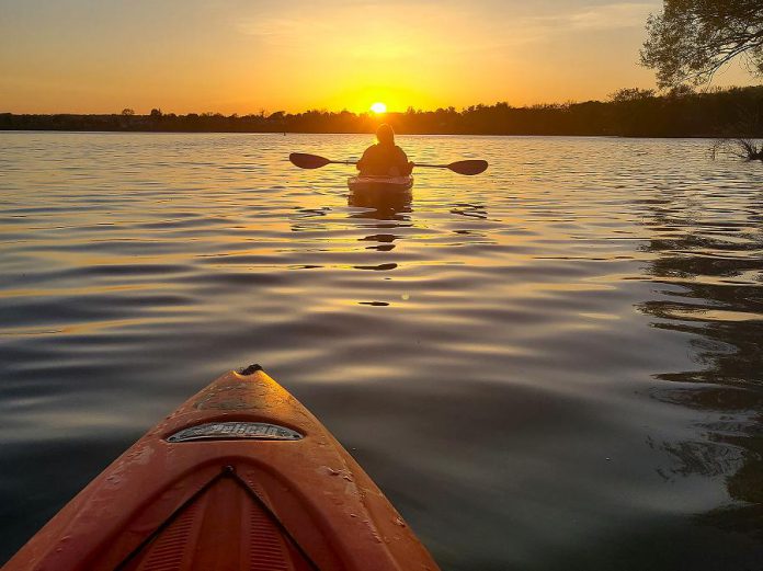 Kayakers enjoy a sunset on Little Lake in Peterborough. Paddling is a physically distanced outdoor recreational activity, and Liftlock Paddle Co. is now offering adult social paddles every Sunday afternoon. (Photo courtesy of Liftlock Paddle Co.)