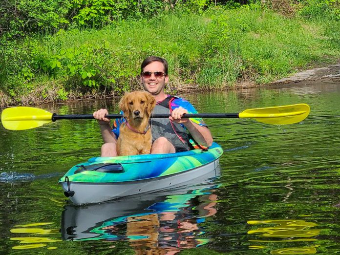 Dogs are welcome when you are renting canoes and kayaks from Liftlock Paddle Co. in Peterborough. Pictured is owner Taryn Grieder's husband Nick with their dog. (Photo courtesy of Liftlock Paddle Co.)