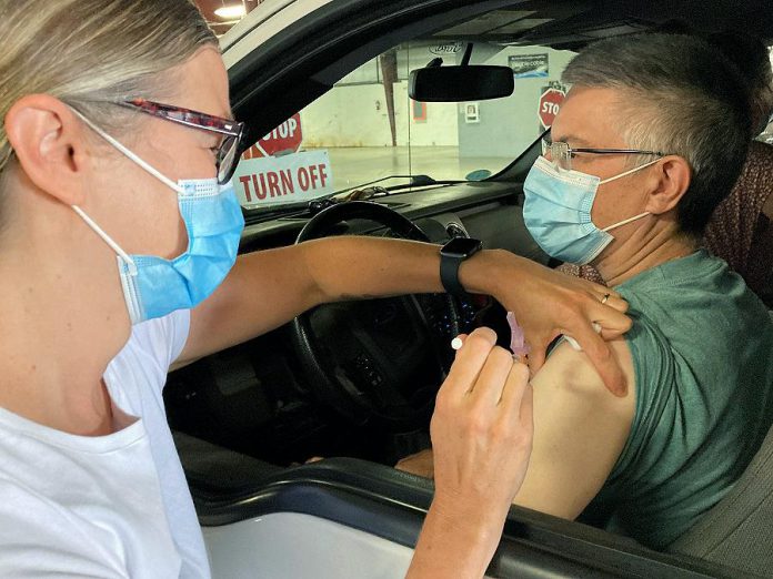 Ron Armstrong of Woodville received his second dose of COVID-19 vaccine at the drive-through vaccination clinic at the Lindsay Exhibition on July 13, 2021, the 50,000th dose administered at the clinic since it opened in March. Carol Henley, a registered nurse at Ross Memorial Hospital, administered the vaccine. (Photo courtesy of Ross Memorial Hospital)