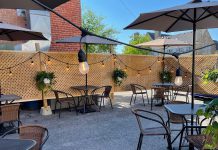 Rare's backlot patio, complete with a fence and lights, is located in the parking lot at the back of the Brock Street restaurant in downtown Peterborough. Rare owners Kassy and Tyler Scott put a lot of work into transforming the space into a patio for outdoor dining, which they will continue to offer even though indoor dining is permitted as of July 16, 2021. (Photo courtesy of Rare)