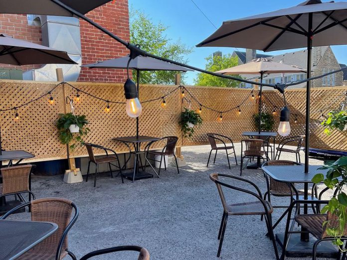 Rare's backlot patio, complete with a fence and lights, is located in the parking lot at the back of the Brock Street restaurant in downtown Peterborough. Rare owners Kassy and Tyler Scott put a lot of work into transforming the space into a patio for outdoor dining, which they will continue to offer even though indoor dining is permitted as of July 16, 2021. (Photo courtesy of Rare)