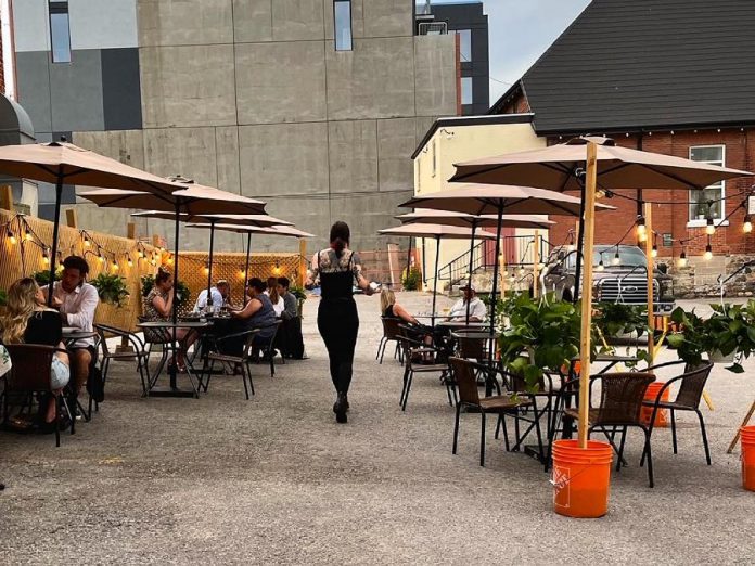 Amber Orde serves dinner on the Rare backlot patio. Reservations for tables on the patio are best made through the Rare website. The Rare patio hours of operation are weather dependent, but indoor dining is now also available at the Brock Street restaurant in downtown Peterborough. (Photo courtesy of Rare)