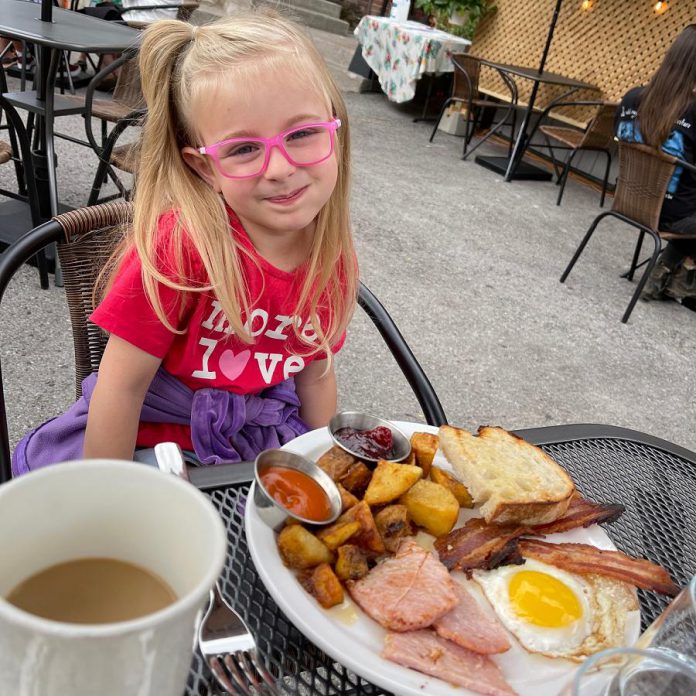 Tyler and Kassy Scott's daughter Isabel enjoys Sunday brunch on the Rare backlot patio. As of July 16, 2021, the Brock Street restaurant in downtown Peterborough is also open for indoor dining.  (Photo courtesy of Rare)