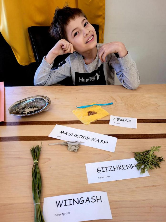 Ashley Wynne's eight-year-old son learning about the four medicines in Anishinaabemowin, the Ojibwe language. Wynne's private school Sage and Sunshine will provide urban Indigenous children with a safe learning environment to experience individualized learning plans that represent unique academic goals.  (Photo courtesy of Ashley Wynne) 