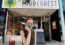 Brianna Wood, sister of The Food Forest's owner Lasair Wood, sits at the single-table patio in front of the vegan restaurant. Thanks to a proposal by landlord Ashburnham Realty, The Food Forest has an additional four tables on a back patio shared with Providence and St Veronus. (Photo: The Food Forest / Facebook)