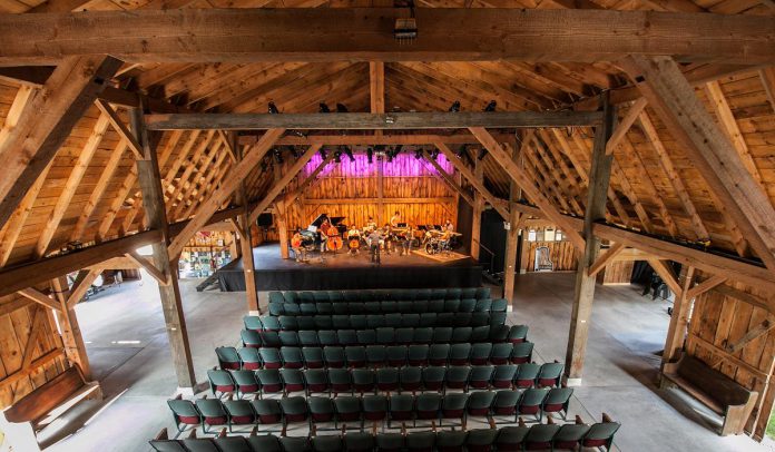 Westben's 'Welcome Back Weekend' starting July 30th will feature concerts on Friday and Saturday night at the new Willow Hill outdoor venue, followed by a concert on Sunday afternoon at Westben's primary performance venue The Barn (pictured). To accommodate pandemic protocols, seating will be limited to 100 people in physically distanced groups. The Barn's massive walls and doors will be rolled away, serving the dual purpose of providing open-air ventilation and allowing guests to experience music and nature at once. (Photo: Wayne Eardley, courtesy of Northumberland County)