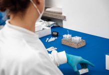 A lab technician evaluates COVID-19 rapid tests. (Stock photo)