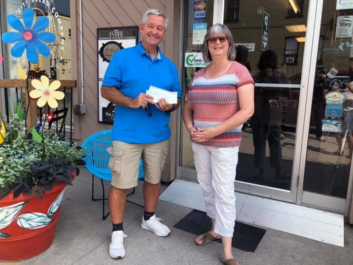 Dave McNab accepting the $1,000 donation from Brenda Ibey, owner of The Avant-Garden Shop, on August 5, 2021. (Photo: Clayton Ibey)