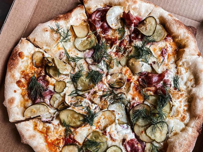 Pizza Bodega specializes in New York style pizza that ranges from traditional to wild. Pictured is the spicy pickle pizza. (Photo: Pizza Bodega)