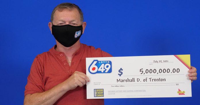 Marshall Dominey with his $5 million Lotto 6/49 prize. (Photo supplied by OLG)