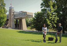 Peterborough-Kawartha MP Maryam Monsef and David Britton, director of Ontario waterways for Parks Canada, with the first of 4,000 trees to be planted along the Trent-Severn Waterway National Historic Site of Canada, which is celebrating its 101st anniversary of through navigation this year. (Photo: Parks Canada)