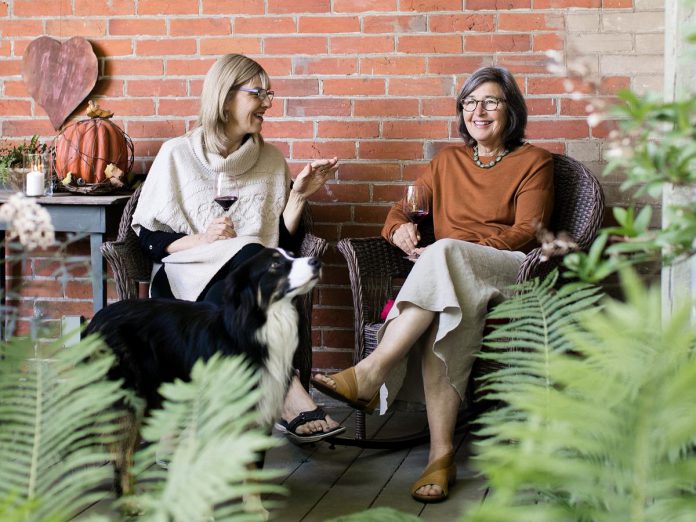 Leslie Scott, owner of Walton Wood Farm in Bailieboro, chats with her friend Danielle French, owner of South Pond Farms in Pontypool, on the porch at South Pond Farms. The two entrepreneurs have teamed up to launch a brand collaboration, with Walton Food Farm expanding its product line by offering French's gourmet food products. (Photo: Ash Nayler Photography)