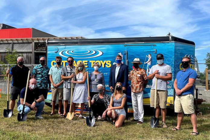 A groundbreaking ceremony for the new retail location of Cottage Toys in Lakefield was held on August 30, 2021. Back row (left to right): ATL Distributing owner Jason Pulchinski, Peterborough Chamber of Commerce president Stu Harrison, Ethan Rork, Andrew Rork, Donna Rork, Deputy Mayor of Selwyn Sherry Senis, Peterborough-Kawartha MPP Dave Smith, Community Futures Board Chair Grant Seabrooke, Tim Fosbery of FourPoints Construction, and Noel Furniss of Diversico Watersports Equipment. Kneeling (left to right): Rob Lamarre of Selwyn Township Building and Planning, Lakefield Ward councillor  Anita Locke, and  Cottage Toys store manager Molly Galvin. (Photo: Cottage Toys)