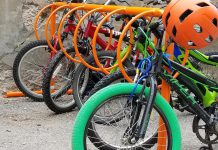 Many schools in Peterborough have front-wheel slot-style racks that are known to cause bike damage and are difficult to lock properly to. A bike rack should provide two points of contact for stability and proper locking. Ring-style bike racks allow two points of contact to properly lock a bike and allow for increased capacity. (Photo courtesy of GreenUP)