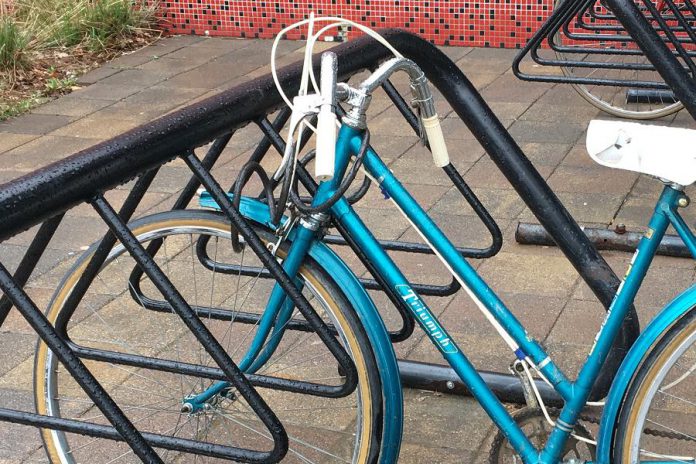 This bike may seem like it is locked, but look closely: the lock does not actually go through the frame. For the best security, a lock should secure the frame as well as both of the wheels.  (Photo courtesy of GreenUP)