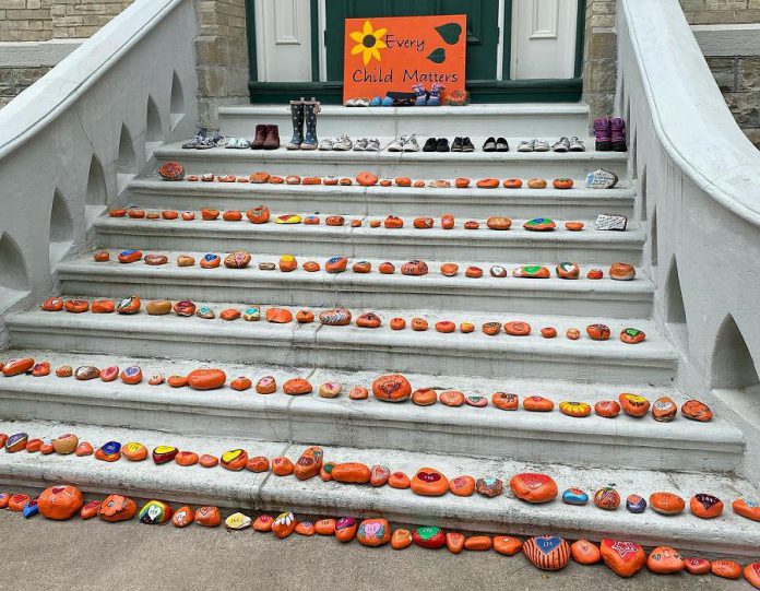 Settler group Truth and Reconciliation Community Bobcaygeon recently installed a  "215+ Taken" memorial on the steps of Kawartha Lakes City Hall, featuring stones painted by more than 50 members of the community (including children) to represent the Indigenous children whose bodies were found buried next to the Kamloops Indian Residential School. (Photo: Truth and Reconciliation Community Bobcaygeon)