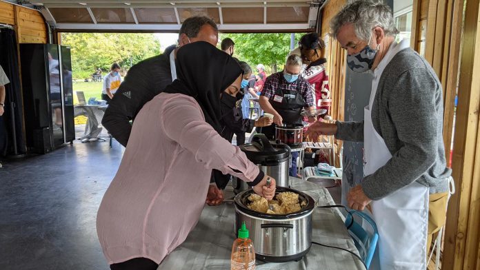 "We tried to create a mac 'n' cheese that we think would be appropriate for students." Trent University president Dr. Leo Groarke offers up mac 'n' cheese during the launch event on September 21, 2021 for Peterborough's inaugural Mac + Cheese Festival during October.  (Photo: Bruce Head / kawarthaNOW)