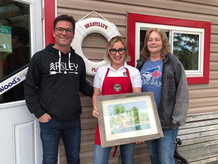 Yannick and Shantelle Bisson after Shantilly's Place (formerly West Bay Narrows Marina) opened on May 17, 2019. Also pictured is artist Terri Butler (right), who gifted the couple a painting of the original West Bay Narrows Marina. (Photo courtesy of Shantelle Bisson)