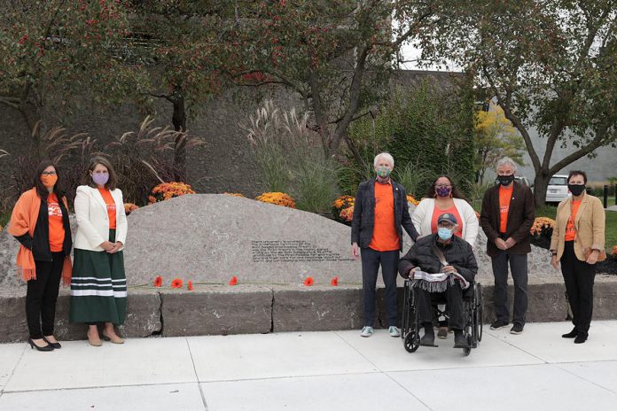 Dignitaries at the unveiling of the treaty rock at Trent University on the inaugural National Day for Truth and Reconciliation on September 30, 2021, which is also Orange Shirt Day, included Curve Lake First Nation Chief Emily Whetung, Curve Lake First Nation Elder Doug Williams, Curve Lake First Nation member Lorenzo Whetung,  Trent University president Leo Groarke, and Trent University vice-president of external relations and development Julie Davis. (Photo courtesy of Trent University)