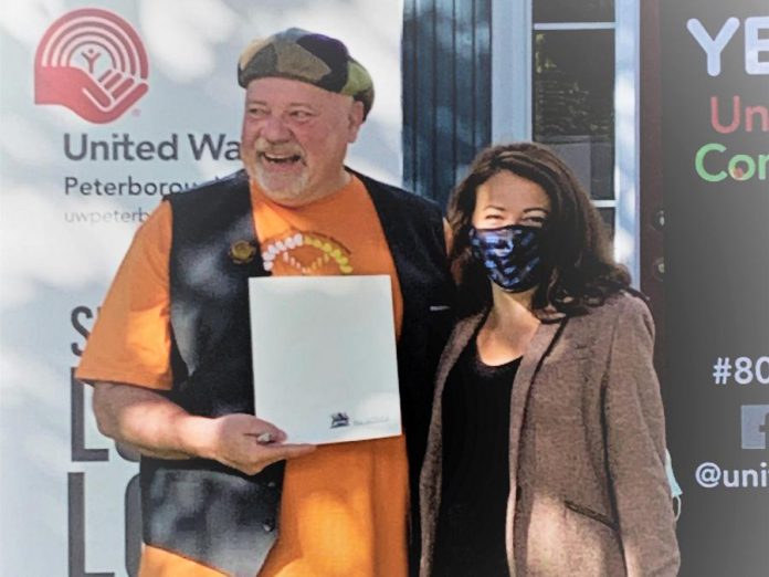 United Way Peterborough & District CEO Jim Russell accepts a proclamation from Peterborough Mayor Diane Therrien recognizing the organization's 80-year commitment to the community during the United Way's 2021-2022 campaign launch on September 29, 2021. (Photo courtesy of United Way Peterborough & District)