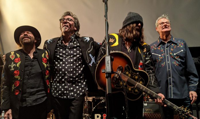 Members of Blackie and the Rodeo Kings take a bow after a sold-out February 21, 2020 performance at Market Hall Performing Arts Centre, one of the final concerts at the downtown performance venue before the pandemic shut down all live music. (Photo: Bruce Head / kawarthaNOW)