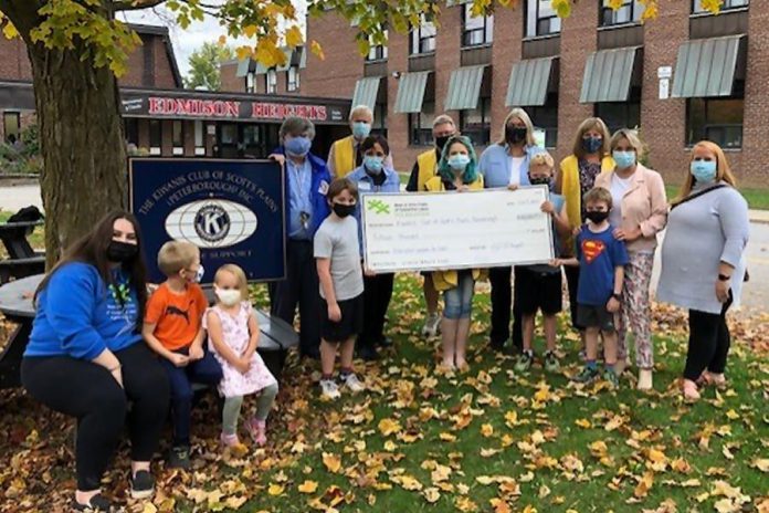 Representatives of BGC Kawarthas Foundation and Kiwanis Club of Scott's Plains, along with several children celebrate the community partnership between the two organizations. (Photo courtesy of BGC Kawarthas Foundation)