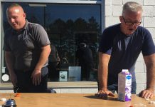 Mark Smith, operations manager of Fitzsimmons Towing and Repair in Peterborough, and retired Peterborough OPP constable Dave McNabb react after eating a ghost pepper in a fundraising event on October 19, 2021 for One City Peterborough, a Peterborough-based organization that is focused on housing, food security, community safety, and inclusion. (Photo: Paul Rellinger / kawarthaNOW)