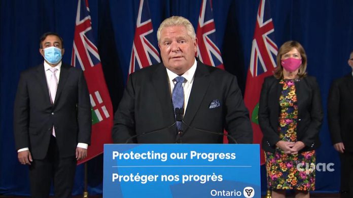 At a Queen's Park media conference on October 22, 2021, Ontario Premier Doug Ford unveiled the government's five-month plan to lift the remaining provincial public health and workplace safety measures. (kawarthaNOW screenshot of CPAC video)