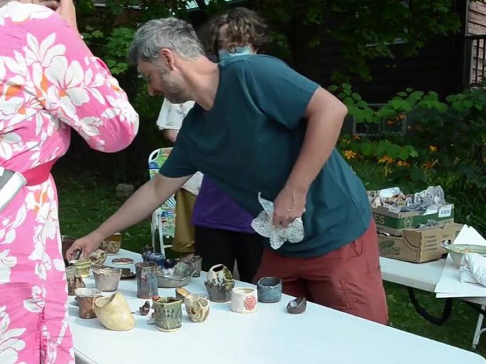 John Marris during "Fire Shift" from May to July 2021, a collaboration between local youth and Peterborough artists to make ceramic work and then experience a traditional outdoor pit firing process, part of Artsweek Shift2. (kawarthaNOW screenshot from Artsweek video)