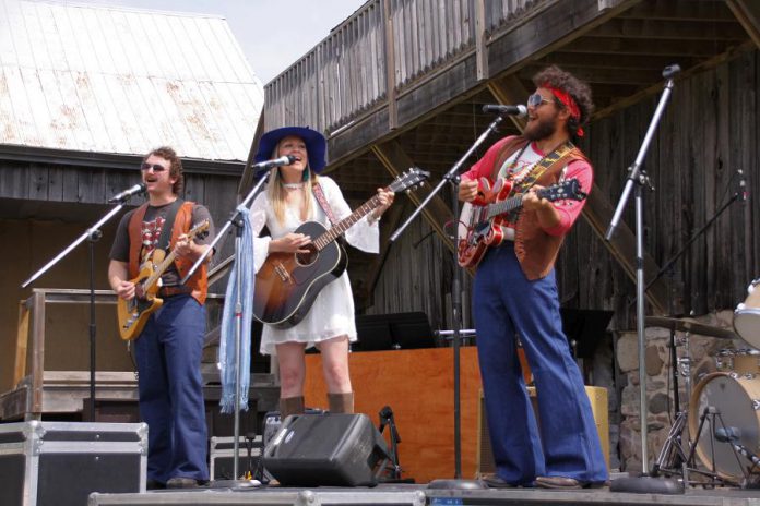 Owen Stahn, Griffin Clark, and Kate Suhr performing original music by Beau Dixon and David Tough for 4th Line Theatre's 2019 production of Beau Dixon's "Bloom: A Rock 'n' Roll Fable" at the Winslow Farm in Millbrook. A cast recording of all eight of the production's original songs is now available, along with a short documentary film about the making of the cast recording. (Photo: Jeannine Taylor / kawarthaNOW.com)