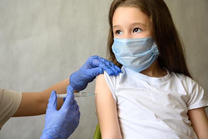 A young girl receiving a vaccination. (Stock photo)