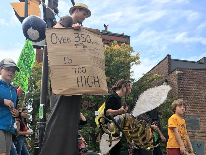 Performer Tim Holland carries a sign that says "Over 350ppm is too high" in the 2019 'Fridays for Future' global climate strike event in Peterborough. Scientific consensus states that 350 parts per million carbon dioxide in the atmosphere is the maximum threshold for sustainable human civilization on the planet. We are currently at over 413 parts per million. Atmospheric carbon dioxide levels today are higher than at any point in at least the past 800,000 years. (Photo: Leif Einarson)