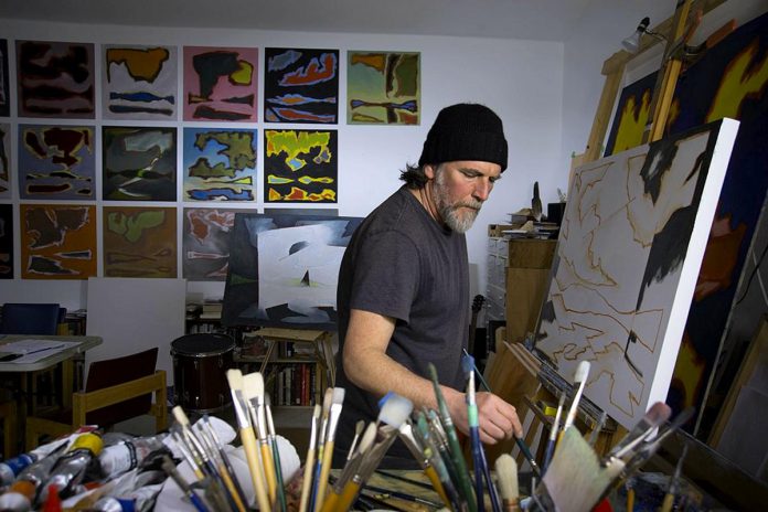 John Climenhage pictured in his studio in 2017 in a photo for Mike Taylor's Peterborough Artists Portrait Project.  (Photo: Mike Taylor)